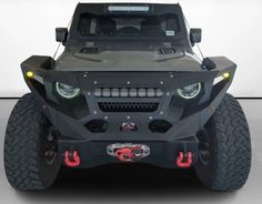 the front view of an armored vehicle with lights on it's headlamps