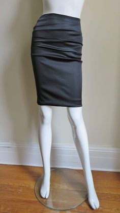 For Sale on 1stDibs - A gorgeous black stretch silk skirt from Dolce & Gabbana. It is a pencil style skirt with horizontal ruching across the front and back. There is functional Elegant Ruched Draped Skirt For Night Out, Elegant Ruched Draped Skirt For Formal Occasions, Elegant Ruched Draped Skirt For Formal Events, Elegant Ruched Skirt For Night Out, Chic Black Draped Skirt With Ruched Detail, Chic Evening Skirt With Ruched Details, Chic Ruched Evening Skirt, Chic Evening Draped Pencil Skirt, Chic Evening Ruched Skirt