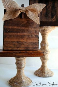 a wooden box with a bow on it sitting on top of a table next to another box