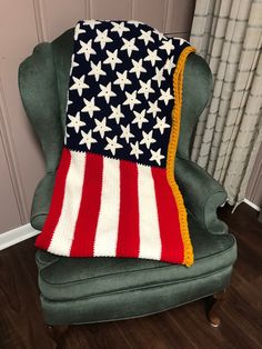 an american flag afghan sitting on top of a green chair