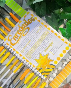 several yellow and white pens sitting next to each other on top of a book cover