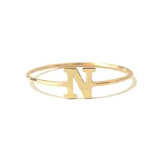 This unique initial letter cut-out is composed of 14K solid gold and beautifully complemented by a durable 14K solid gold band. Initial Letter Dimensions: approximately 5mm (w) x 5mm (h) Band Thickness: approximately 1.25mm Metal Finish: High Shine Polish This design is available in Rose, White and Yellow 14K Gold Please note that this item takes about 1 to 3 business days for production, prior to shipping. This item is proudly made in USA. *This piece comes in a Nana Bijou branded white leather Custom Alphabet, Solid Gold Charms, Block Font, Charm Ring, Letter Ring, Solid Gold Band, Initial Ring, Gold Initial, Charm Rings