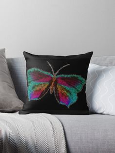 a colorful butterfly on a black background throw pillow