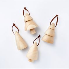 four pieces of wood are arranged in the shape of christmas trees on a white background