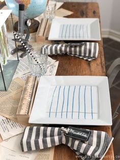 a wooden table topped with plates and napkins