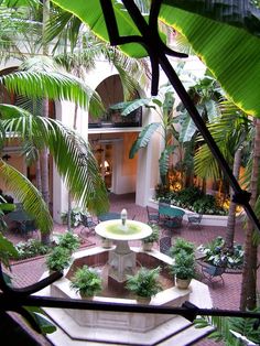 an indoor courtyard with fountain and seating area