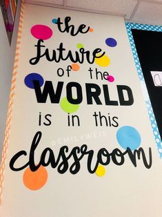 a sign that says the future of the world is in this classroom with colorful dots