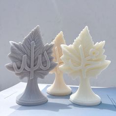 three ceramic trees sitting on top of a table