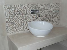 a white bowl sink sitting on top of a counter