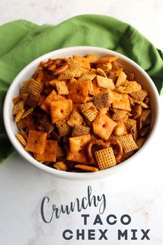 a white bowl filled with chex mix