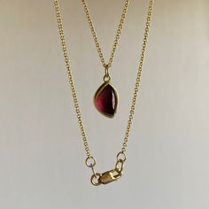 Whimsical yet tantalizing, this foliage-shaped garnet is simply unforgettable. 22k & 18k yellow gold Rhodolite garnet 7mm x 10mm (1/4" x 7/16")1.3mm cable chain is adjustable and can be worn at 17" or 20" Yellow Gold Garnet Necklaces With Oval Shape, Gold Oval Tourmaline Necklace, Yellow Gold Oval Garnet Necklace, Classic Gold Tourmaline Jewelry, Gold Oval Garnet Necklaces, Yellow Gold Ruby Teardrop Necklace, Teardrop Ruby Necklace In Yellow Gold, Yellow Gold Teardrop Ruby Necklace, Oval Garnet Gold Necklace