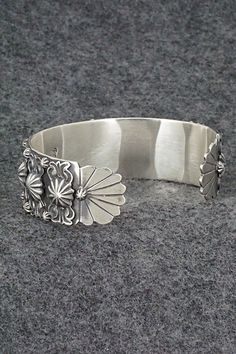 This sterling silver bracelet was made by Navajo silversmith Bobby Platero. The inside is signed RB and stamped .925.Size: 5 3/4" (will fit up to a 6 7/8" wrist)Gap: 1 1/8"Length: 3/4"Free shipping on all orders! We ship with USPS and always include tracking. All orders ship within a day of payment.Returns are accepted up to 30 days after you receive your order. Just send us a message. Our shop offers cash back or store credit. The item must be returned in new condition. Unique Sterling Silver Concho Jewelry, Artisan Sterling Silver Concho Cuff Bracelet, Artisan Silver Concho Cuff Bracelet, Southwestern Silver Jewelry With Sterling Silver Clasp, Southwestern Silver Bracelets With Concho, Oxidized Sterling Silver Southwestern Bracelet, Oxidized Finish Southwestern Sterling Silver Bracelet, Silver Southwestern Style Bracelet With Oyster Clasp, Vintage Silver Bracelets With Concho