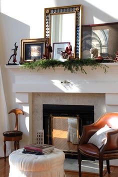 a living room with a fire place and pictures on the mantle