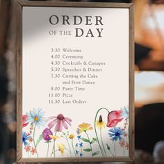 a sign with flowers on it that says order of the day