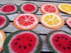 several slices of watermelon and orange on a wooden table