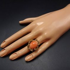 "ESTATE 14 KARAT GOLD and SALMON CORAL RING DESCRIPTION: This elegant ring features a large cabochon of pink salmon coral, placed in an organic setting of heavy gauge 14 karat yellow gold. This ring will be a valuable addition to your collection of fine vintage jewelry. MEASUREMENTS: Ring face measures 1\" north to south RING SIZE: 6 Domed coral cabochon measures 18mm x 13mm x 7mm WEIGHT: 15.9 grams SIGNED: no GOLD: Marked 14K" Coral Oval Jewelry For Weddings, Coral Vintage Jewelry For Anniversary, Vintage Coral Jewelry For Anniversary, Formal Coral Oval Jewelry, Formal Coral Jewelry With Cabochon, Formal Coral Ring, Formal Coral Jewelry With Cabochon Details, Vintage Coral Rings As A Gift, Coral Cabochon Jewelry For Gift