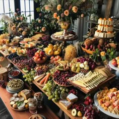 a table filled with lots of different types of foods and desserts on top of it