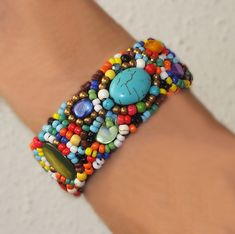 COLOR MANIA. WOW! These amazing color combinations will lift up any outfit. The wild combination of shell, stones, turquoise and beads is really special. All elements intricately woven into a 1 cm wide macramé flexible cuff it is effortless to put on and remove. And this bracelet is super comfy and fits like a glove. You will definitely get a lot of comments on these beauties - and it looks fabulous with your LBD (little black dress). The vibrant colors really pop! The diameter is about 5cm and at the irresistible price of only $US38 you can pick up a few. Each one is a unique work-of-art. It would make a fabulous gift for that special someone who likes bright pieces. And it comes with a complementary felt gift bag. FREE SHIPPING TO ABSOLUTELY ANYWHERE Thanks for visiting ARTMANIA Multicolor Natural Stone Beaded Bracelets For Festivals, Multicolor Bohemian Hand Wrapped Cuff Bracelet, Festival Multicolor Macrame Beaded Bracelets, Bohemian Multicolor Round Beads Cuff Bracelet, Bohemian Multicolor Beaded Macrame Bracelets, Bohemian Multicolor Beaded Cuff Bracelet, Bohemian Multicolor Macrame Beaded Bracelets, Bohemian Beaded Cuff Bracelet For Beach, Traditional Multicolor Macrame Beaded Bracelets