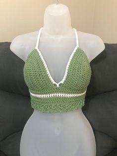 **Top will automatically come with white color trim unless you specifically pick a different color for it** -Hand crocheted crop top perfect for the warm summer months at the beach, or at any festival.  -Made with I Love This Cotton Yarn -The size of this top works best for someone who is 'Medium C cup' -Adjustable corset style tie in the back and a tie around the neck  -Hand wash with cold water and white vinegar to help set the color in place. Color will fade over time.  *Top will slightly shrink after the first wash* Green Crop Top For Vacation, Green Crochet Trim Summer Top, Green Crochet Lace Crop Top For Summer, Green Summer Crochet Top With Crochet Trim, Green Crochet Top With Crochet Trim For Festival, Fitted Green Crochet Top For Summer, Spring Festival Halter Top With Crochet Trim, Fitted Green Crochet Top For Beach Season, Green Fitted Cropped Crochet Top