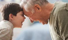 an older man and young boy are smiling at each other