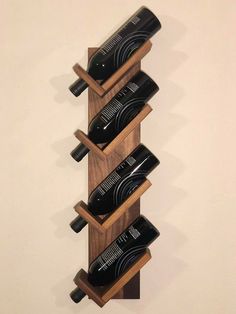 a wooden wine rack with several bottles on it