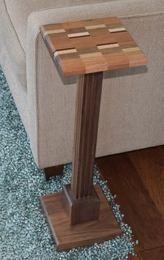 a wooden table sitting on top of a blue carpeted floor next to a couch