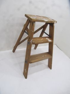 *A great little ladder that is a perfect decorative piece for any home.  Use as an accent piece, plant stand, or step stool for those hard to reach items.  The ladder is in natural vintage condition with very little wear on the wood or rust on the metal.  The ladder does fold out easily and does hold weight if would need to use as a step stool. Measurements: 15.25" wide 17.75" deep   22" high Top step  12" x 5.5" First step  7" off the floor  12" x 3.25" Second step  14.25" off the floor  10" x 3.25"  #26 Stool Measurements, Stool Plant Stand, Farmhouse Stools, Rustic Ladder, Folding Step Stool, Support Pour Plante, Wooden Ladder, Small Step, Step Ladder