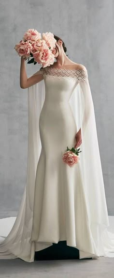 a woman in a wedding dress holding flowers