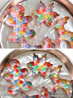 there are many different colored cookies on the pans and one is made out of candy