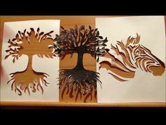 three paper cut out of different types of trees