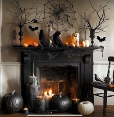 a fireplace decorated with halloween decorations and candles