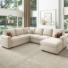 a living room with a sectional couch and large windows