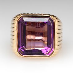 This amazing ring features a fluted design and is accented with one (1) emerald cut natural amethyst set into a bezel setting. The ring measures 16.1mm at the top, rises 7.6mm above the finger, tapering to 6.3mm wide and 1.3mm thick at the base of the shank. It is currently a size 4.75. Luxury Purple Ring With Bezel Setting, Luxury Emerald-cut Amethyst Ring For Formal Events, Luxury Emerald Cut Amethyst Ring For Formal Occasions, Luxury Amethyst Ring Emerald Cut, Luxury Emerald Cut Amethyst Ring, Luxury Yellow Gold Amethyst Ring With Emerald Cut, Luxury Formal Jewelry With Fluted Bezel, Luxury Purple Amethyst Ring, Rectangular Shape, Luxury Purple Amethyst Rectangular Ring