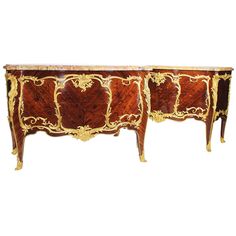 an ornately decorated sideboard with gold accents