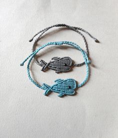 Macrame whale bracelet, Mommy and kid Ciel blue Unisex, Adjustable, Sea lover gifts Surfer Braided waxed cord jewelry Gift for him her This handknotted whale is made using waxed string has a little black seed bead for an eye. It is adjustable with a sliding knot closure to fit a lot of sizes. Custom orders for different color combinations are welcome. SIZE: 36 x 19 mm Other macrame fish in my shop: https://www.etsy.com/listing/183535663/burgundy-cute-little-fish-macrame-short?ref=shop_home_activ Blue Adjustable Cord Braided Friendship Bracelets, Blue Adjustable Cord Braided Bracelets For Friendship, Blue Friendship Bracelets With Sliding Knot, Adjustable Cord Friendship Bracelets As Gift, Blue Adjustable Cord Friendship Bracelet Gift, Handmade Friendship Bracelets With Waxed Cord, Blue Braided Bracelets With Adjustable Cord As Gift, Blue Braided Bracelet With Adjustable Cord As Gift, Adjustable Cord Braided Bracelet As Gift