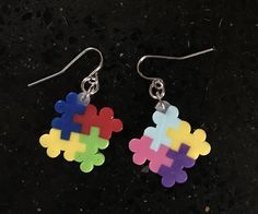 the earrings are made out of colored plastic pieces with silver earwires on them