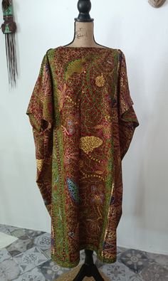 This caftan tunic will become one of your favorite pieces! African fabric print multicolored burgundy, green, blue 100% Cotton Wax Print Fabric Without lining The cut of the tunic is straight and wide with the sleeve above the elbow. Width of neckline approx 30-32cm Rounded boat neckline or V-neckline as per your choice Tunic measurements 100cm wide and 114cm long If you need other measurements, write to us! Green Tunic Kaftan For Festivals, Green Batik Print Kaftan For Festival, Traditional Green Batik Print Kaftan, Green Traditional Kaftan With Kimono Sleeves, Traditional Green Kaftan With Batik Print, Traditional Green Kaftan With Kimono Sleeves, Bohemian Brown Printed Kaftan, Traditional Brown Kaftan With Kimono Sleeves, Green Bohemian Kaftan With Traditional Patterns