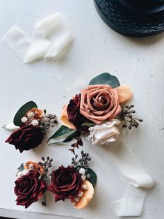 some flowers are laying on a white surface