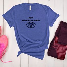 Awaken Your Intuition with our Ajna Third Eye Chakra Indigo T-Shirt - Enhance Insight and Inner Wisdom! Embark on a journey of heightened intuition and inner wisdom with our captivating Ajna Third Eye Chakra Indigo T-Shirt. This extraordinary garment is not just a t-shirt - it's a symbol of intuition, insight, and the profound energy of your Third Eye Chakra. Indulge in the deep indigo color of our Ajna Third Eye Chakra T-Shirt, which resonates with the expansive realm of higher consciousness. This shirt serves as a reminder to trust your inner guidance and tap into the infinite well of wisdom that lies within you. Designed with both style and comfort in mind, our Ajna Third Eye Chakra Indigo T-Shirt is crafted from premium-quality fabric that feels soft against your skin. Its unique desig Indigo Chakra, Bohemian Blue Graphic Print T-shirt, Blue Crew Neck T-shirt For Yoga, Bohemian Blue Printed T-shirt, Boho Tshirt, Adjustable Hand-strung Turquoise Spiritual Necklace, Cool Clocks, Indigo Colour, Inner Wisdom