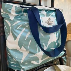 a blue and white bag sitting on top of a chair