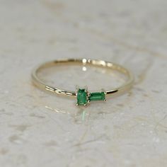 14k Solid Gold Birthstone Baguette Ring. Real Gold Dainty Stackable Bitystone Band. Premium Fine Jewelry For Her. 💙 Our jewelry is handcrafted with love and great care at San Francisco Bay! All of our items are 14k stamped for authenticity. 💙 You will receive them exactly as pictured. We don't use any filters, all photos are authentic and unedited.  💙 Dimensions - Band Width: 1.10 mm. Figure Height: 4.50 mm, Figure Length: 9.20 mm.  💙 The ring material is 14k Solid gold, should not be confused with gold plating or filling. It won't tarnish or fade over time. 💙 We're offering the finest quality in solid gold jewelry. 💙 Quick shipping - Your order will be handcrafted and shipped in a few days. 🎁 They are delivered in a nice jewelry box, ready to be presented as a precious gift. 💙 We Luxury Dainty Emerald Ring As Birthstone, Luxury Dainty Emerald Ring With Birthstone, Luxury Dainty Birthstone Ring With Single Diamond, Luxury Dainty Emerald Birthstone Ring, Emerald Baguette Ring, Emerald Band Ring, Emerald Wedding Band, Alexandrite Jewelry, Emerald Band