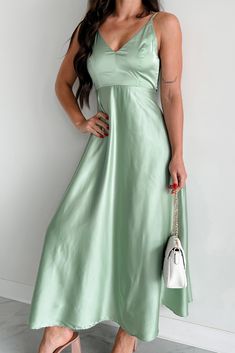 SELF: 98% POLYESTER, 2% SPANDEX. LINING: 88% POLYESTER, 12% SPANDEX Model Wearing Size Small Color: Pastel Sage Satin Material Adjustable Straps V-Neckline Back Tie Detail Back Zipper Closure Lined Midi Length Dress Has Little Stretch 43" Armpit To Hemline For Model Size Specs Please Check Size Charts Launched: 5/30/24 Feminine Green A-line Midi Dress, Spring Green Satin Slip Dress, Green Satin Slip Dress For Spring, Elegant Light Green Spring Midi Dress, Elegant Light Green Midi Dress For Spring, Green Satin Dress For Spring, Chic Light Green Midi Dress For Spring, V-neck Slip Dress For Spring, Spring V-neck Solid Color Slip Dress