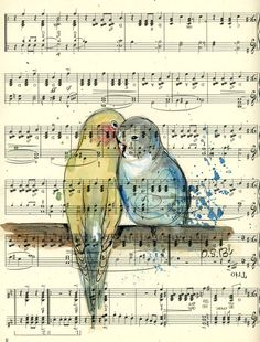 two birds sitting on top of a music sheet