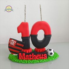 a birthday cake with the number ten and soccer ball on it's top tier