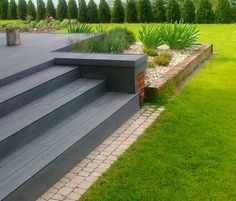 an outdoor area with steps, grass and flowers