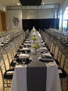 the tables are set up with black and white linens for an event or conference