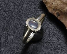 This water clear Opal cabuchon Originates from Mines in Queretaro Mexico. I set this opal in a simple sterling silver band.This piece is stamped 925. Size: 6 Weight: 3.4gm. Sterling Silver Oval Cabochon Moonstone Ring, Oval Cabochon Moonstone Ring In Sterling Silver, Silver Moonstone Oval Cabochon Ring Stamped 925, Unique Silver Oval Cabochon Moonstone Ring, Unique Silver Moonstone Ring Oval Cabochon, Unique Silver Moonstone Ring With Oval Cabochon, Untreated Oval Silver Moonstone Ring, Minimalist Silver Moonstone Ring With Polished Finish, Silver-tone Opal Ring With Cabochon Moonstone