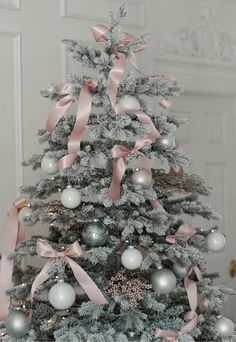 a decorated christmas tree with pink and silver ornaments