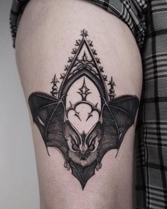 a bat tattoo on the thigh