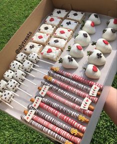 a box filled with cake pops covered in white frosting